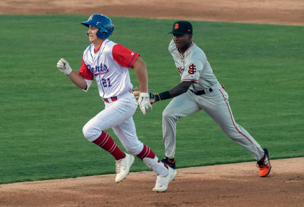 SF Giants prospect Marco Luciano tags A's prospect Tyler Soderstrom.